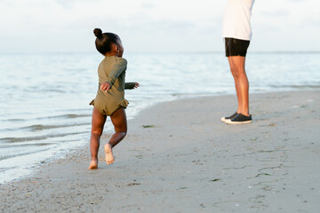 Toddler running on the beach