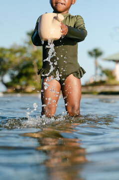 Girl Spilling Water Out Of A Can