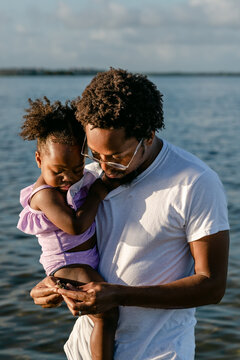 Father examines a shell with daughter