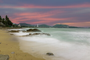 Colourful Skies Sunset over Patong Beach in Phuket island Thailand. Lovely turquoise blue waters, lush green mountains colourful skies and beautiful views of Pa Tong