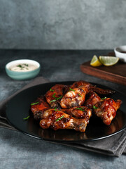Roasted chicken wings with spices. Served with sauce