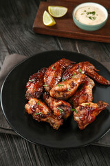 Roasted chicken wings with spices. Served with sauce