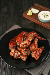 Roasted chicken wings with spices. Served with sauce