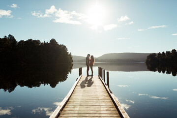 Intimate couple solace on lake dock