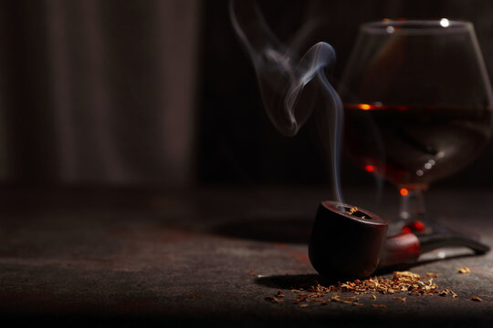 Composition of relaxation with smoking pipe and whiskey - Powered by Adobe