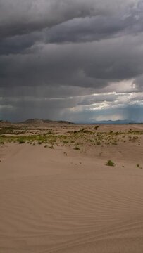 Dangerous thunderstorm moving over the landscape at Little Sahara desert during summer in Utah.