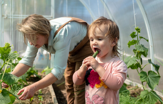 female farmer with child in the garden