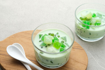 Buko Pandan, a dessert from Philippines, made from jelly, young coconut, evaporated milk, sweetened condensed milk, and ice. Served on glass with cheese topping. 
