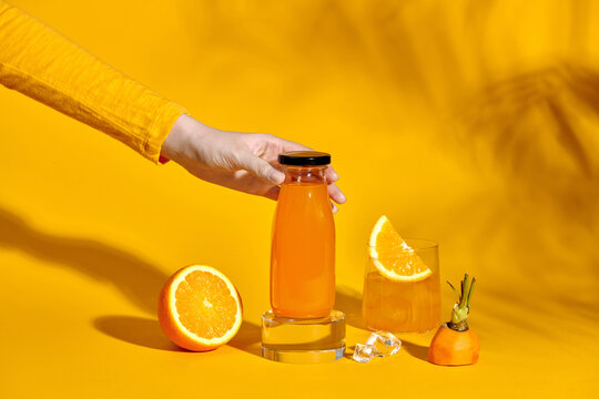 Refreshing orange-carrot juice in a glass on a vivid