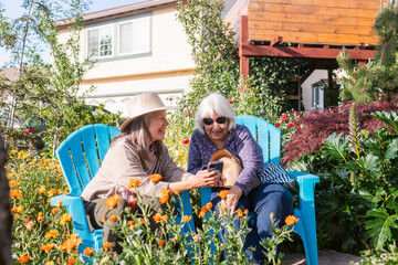 Women sharing phone at garden