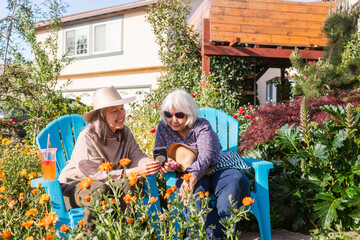 Happy women chatting at blooming garden