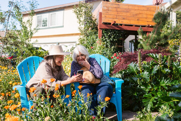 Happy women chatting at blooming garden