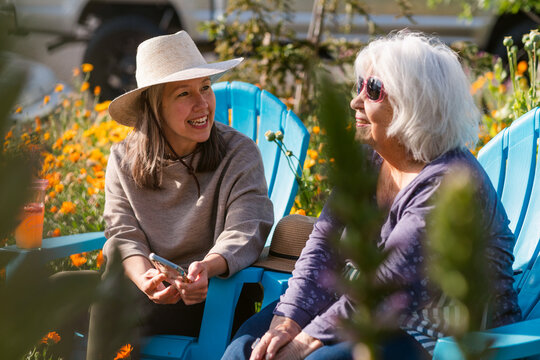 Happy women chatting at blooming garden