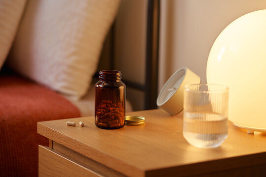 Pills in jar on bedside table.
