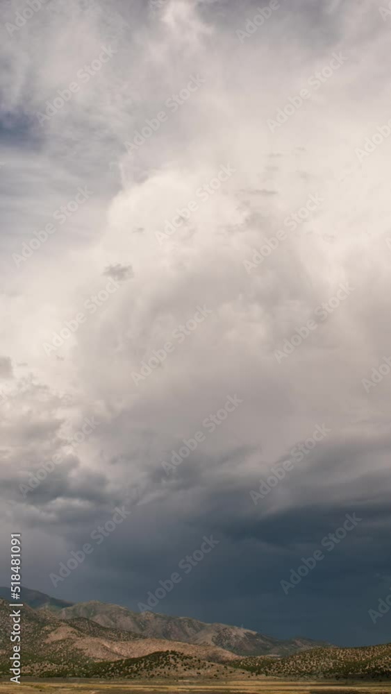 Canvas Prints time-lapse of clouds moving over landscape in utah with flat top mountain in the distance by cedar v