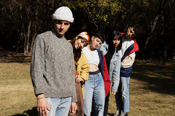Large group of friends together in a park having fun