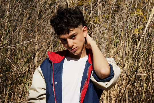 Portrait of very fashionable young man in the park
