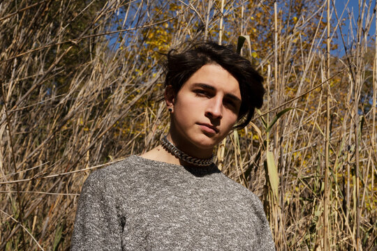 Young man in the park with gray sweater