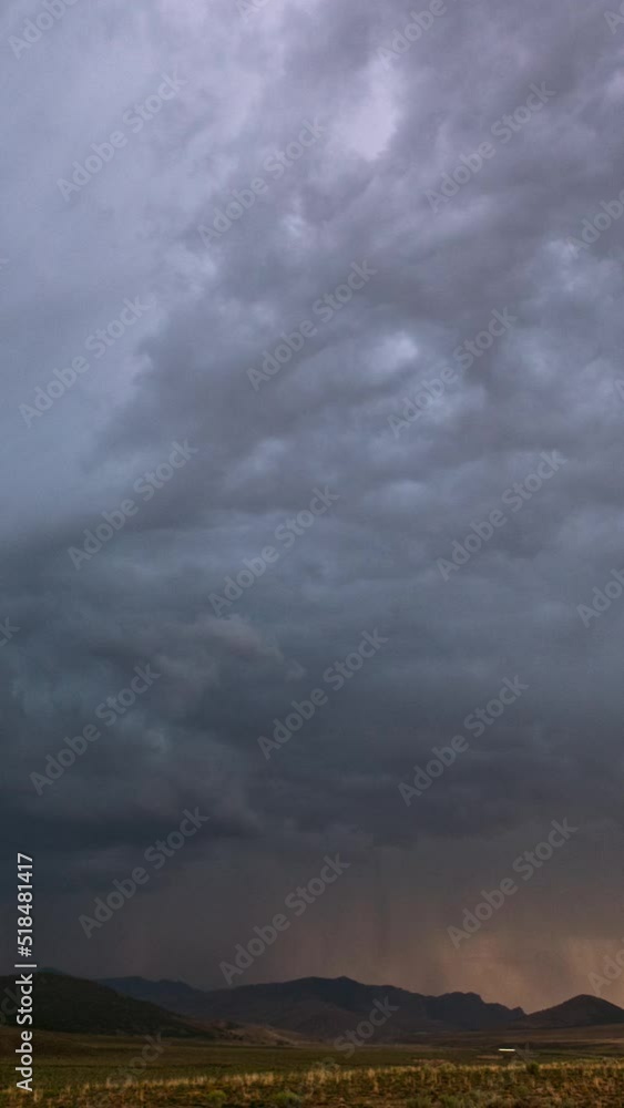 Canvas Prints lightning flashing as storm clouds move over the landscape in utah during sunset.