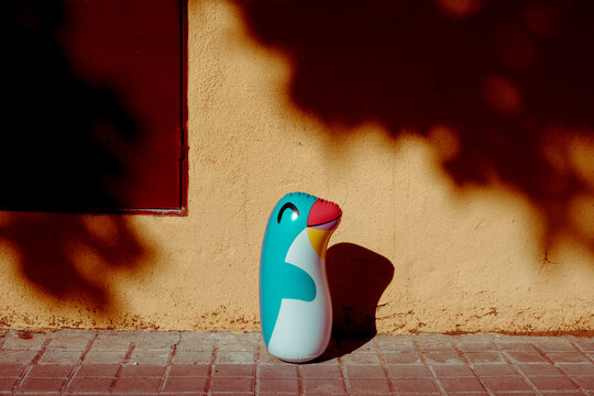 lonely penguin-shaped floaty on the street