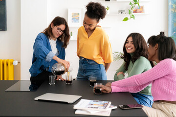 Happy diverse designers having coffee break in studio