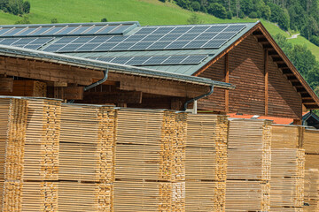 Lots of planks stacked on top of each other in the warehouse. Lumber for further use in construction. Pile of sawn boards