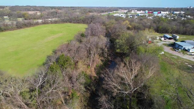 Aerial footage of Post Oak Creek in Sherman Texas. Drone is flying slowly approximately east.