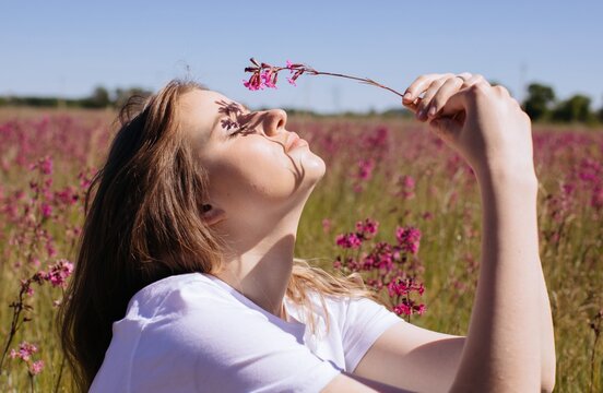 Profile Portrait Of Woman With Flowers Outdoors