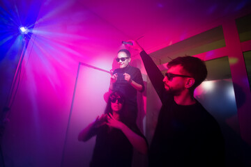 Friends having fun with lights at the party