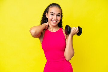 Young sport woman making weightlifting isolated on yellow background laughing