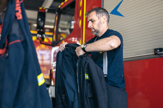 Firefighters putting on uniform