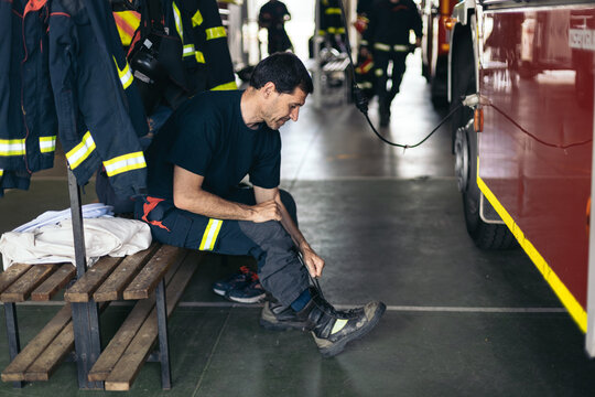 Firefighters putting on uniform