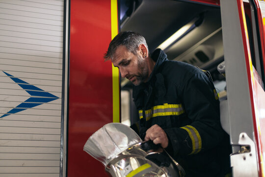 Firefighter getting off the fire truck