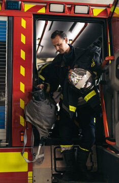 Firefighter getting off the fire truck