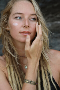 young woman applying sunblock