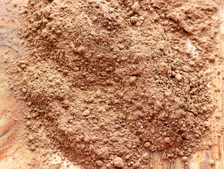Cocoa powder scattered on the wooden board.