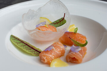 Salmon carpaccio with shio koji, yuzu juice, and olive oil in an ice sphere