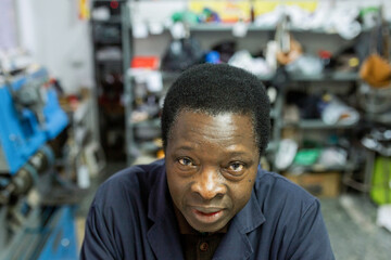 portrait of black man cobbler in his business