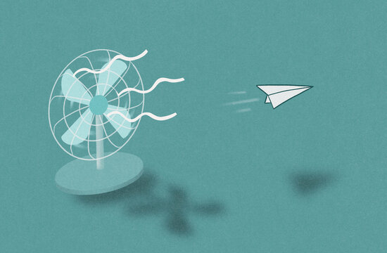 Desk fan with paper airplane