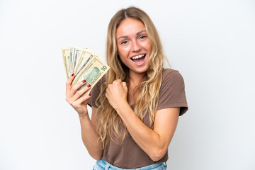 Young Russian woman taking a lot of money isolated on white background celebrating a victory