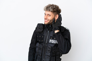 Fototapeta premium SWAT caucasian man isolated on white background listening to something by putting hand on the ear