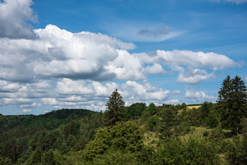 a wooded valley in swabian alb with cloudy sky