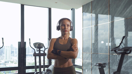 Fototapeta na wymiar Portrait of fit healthy Asian woman, person, doing exercise, working out, and training in gym or fitness center in sport and recreation concept. Lifestyle activity.