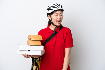 Young Chinese delivery woman taking takeaway food isolated on white background laughing in lateral position