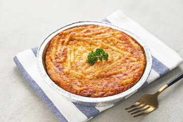 Baked Macaroni Schotel in an aluminium foil cup. Selective focus.
