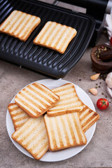 Morning homemade snack - Toast bread pan fried on black electric kitchen grill