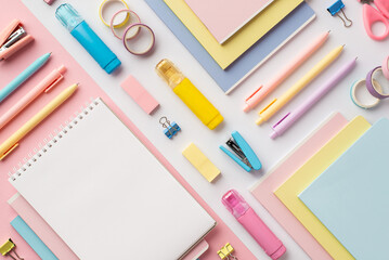 Back to school concept. Top view photo of colorful stationery copybooks pens staplers binder clips...