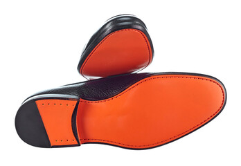 View of the sole of a bright orange color of a beautiful pair of men's suit leather shoes. Comfort and elegance for every day.