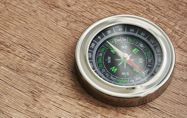 round compass on wooden background. symbol of tourism with a compass. concept travel with compass                      