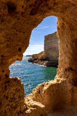 View from the Boneca's Cave to the ocean. A sunny day on the coast of Lagoa, Algarve, Portugal